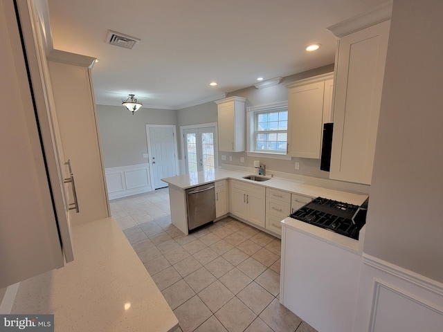 kitchen featuring sink, white cabinetry, dishwasher, and kitchen peninsula