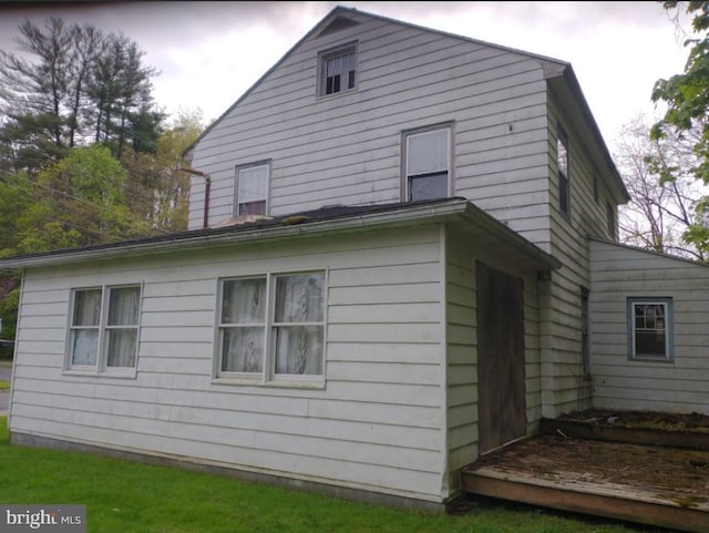 rear view of property with a wooden deck