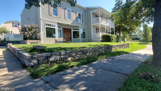 rear view of property featuring a yard