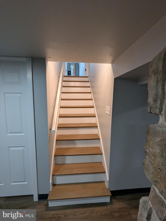 stairs with hardwood / wood-style floors