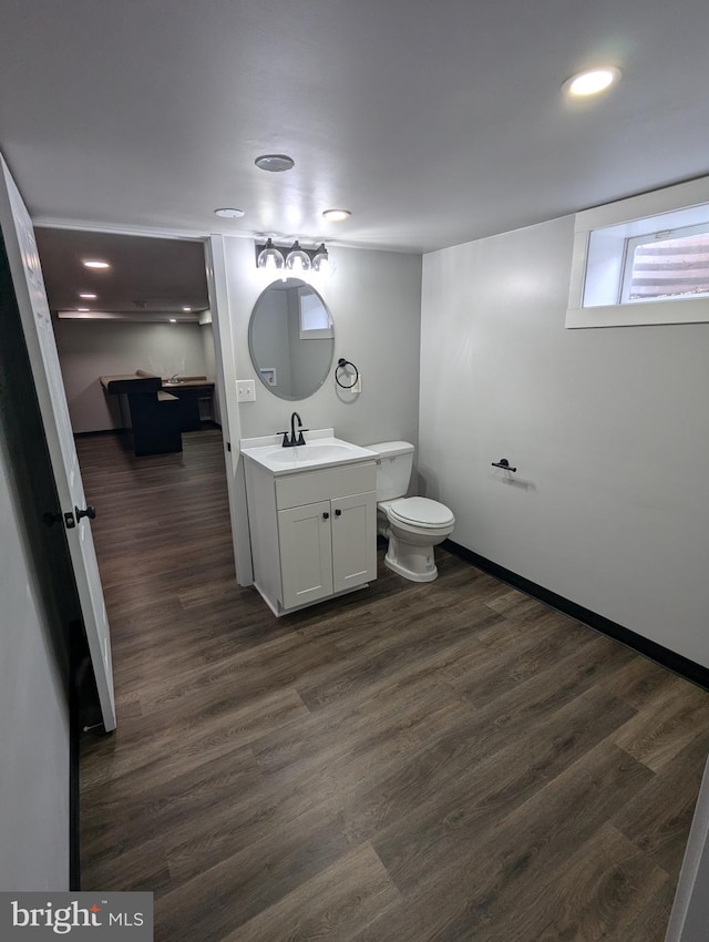 bathroom with vanity, hardwood / wood-style flooring, and toilet