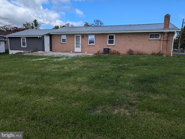 back of property with a yard and cooling unit