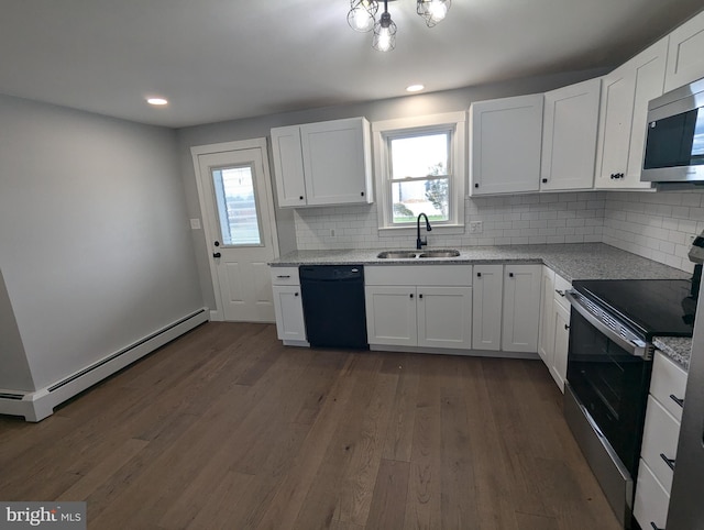 kitchen with appliances with stainless steel finishes, a baseboard radiator, sink, white cabinets, and dark hardwood / wood-style floors