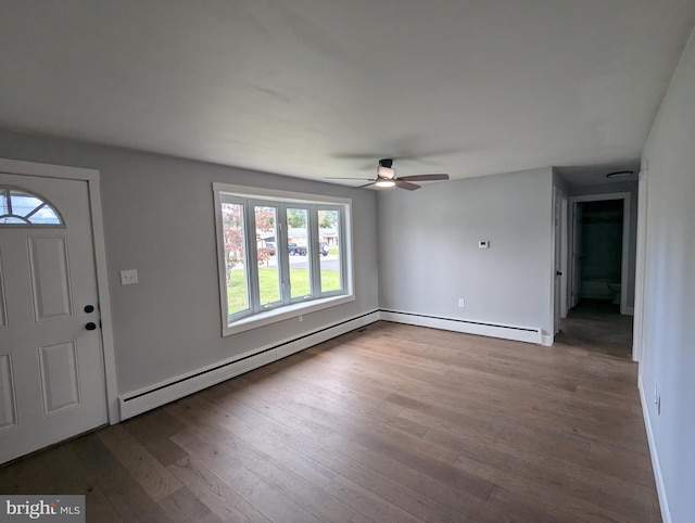 foyer featuring light hardwood / wood-style floors, baseboard heating, and ceiling fan