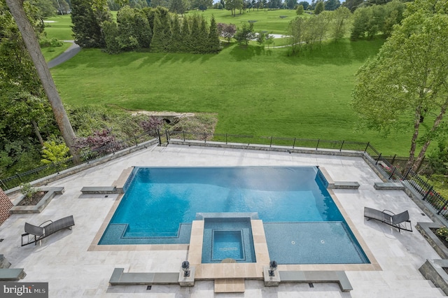 view of swimming pool featuring a patio area and a yard