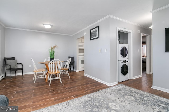 dining space with ornamental molding, dark wood-type flooring, and stacked washer and dryer