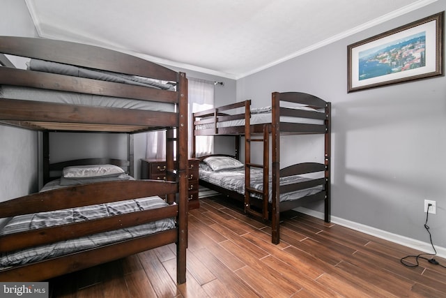 bedroom featuring dark wood-type flooring and crown molding