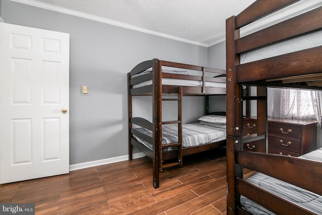 bedroom featuring crown molding and dark wood-type flooring