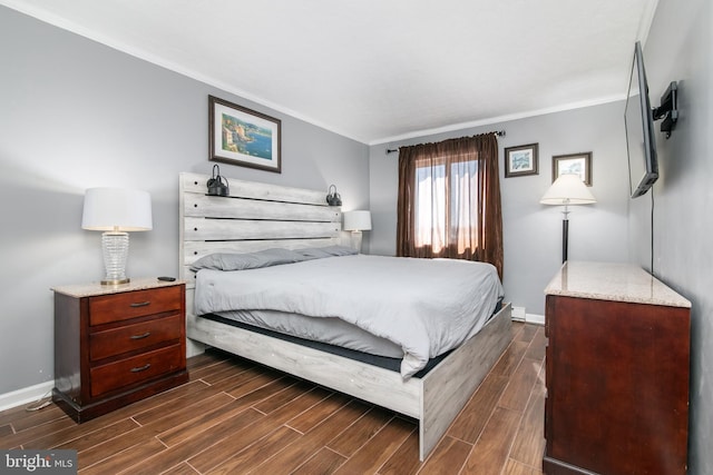 bedroom featuring crown molding and dark hardwood / wood-style flooring