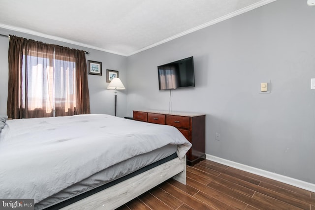 bedroom with ornamental molding and dark hardwood / wood-style floors