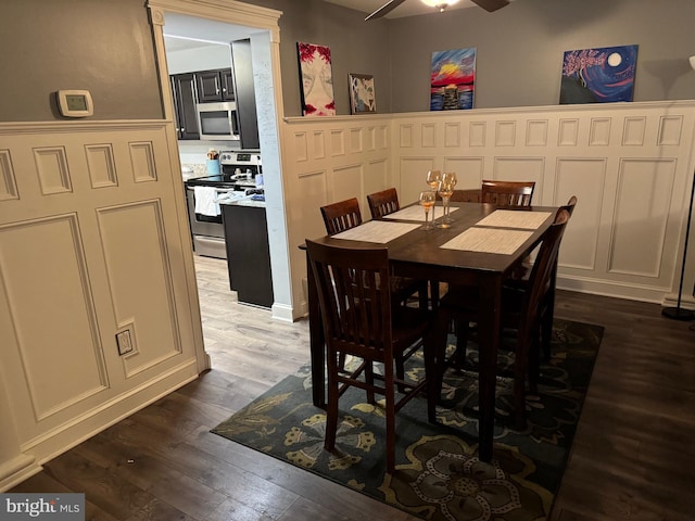 dining area with hardwood / wood-style floors and ceiling fan