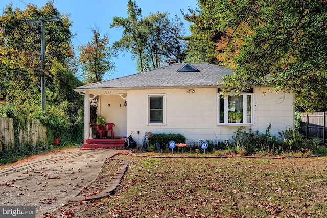 single story home with fence and a shingled roof