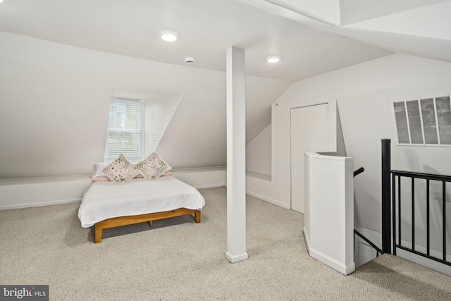 carpeted bedroom featuring vaulted ceiling