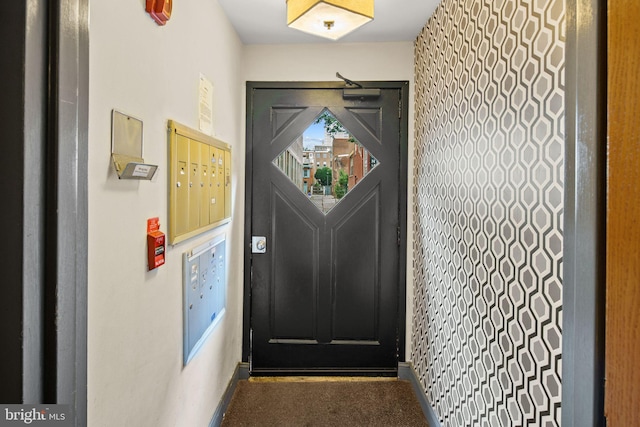 entryway with carpet floors and a mail area