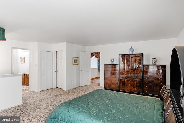 carpeted bedroom featuring ensuite bath