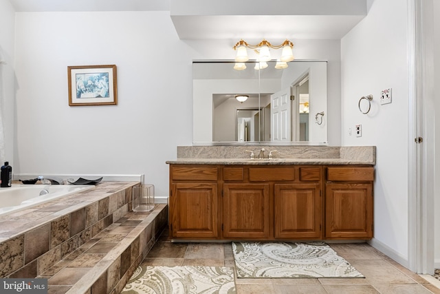 bathroom with vanity, tiled bath, and tile patterned flooring