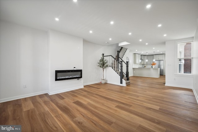 unfurnished living room featuring light hardwood / wood-style floors