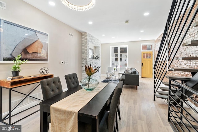 dining space with light hardwood / wood-style flooring