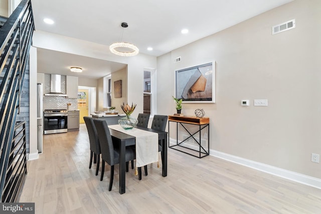 dining space with light wood-type flooring