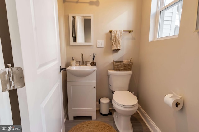 bathroom with vanity, hardwood / wood-style flooring, and toilet