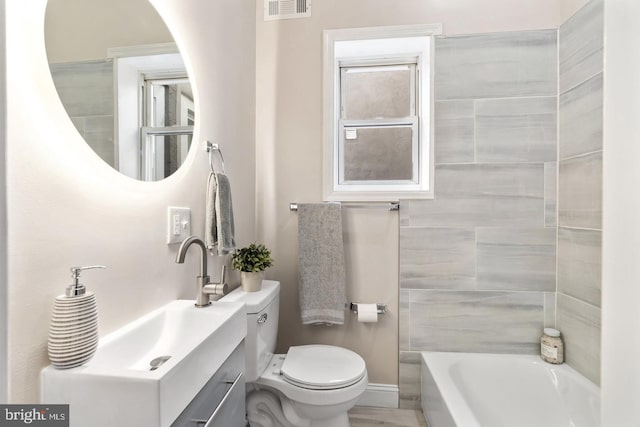 full bathroom featuring toilet, vanity, and independent shower and bath