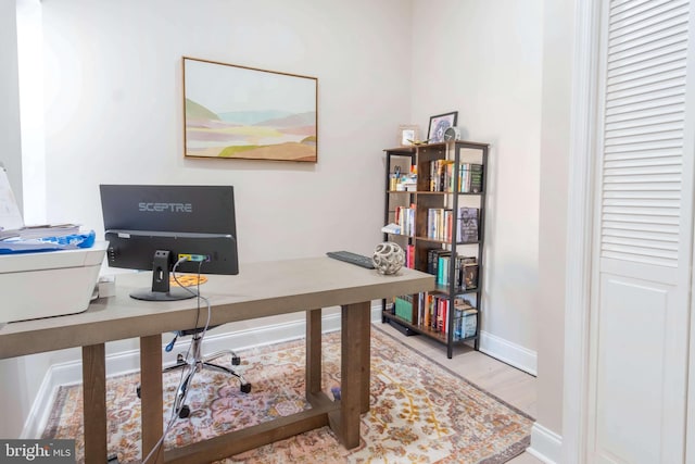 home office with hardwood / wood-style flooring