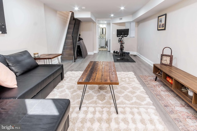 exercise room featuring light wood-type flooring