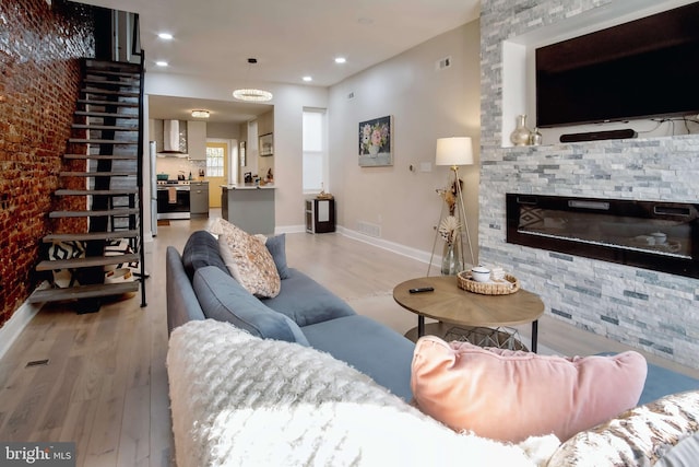 living room with a fireplace and light hardwood / wood-style floors