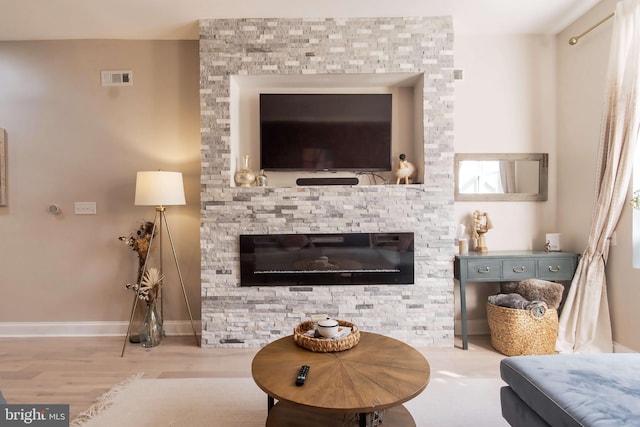 sitting room with light hardwood / wood-style flooring and a fireplace