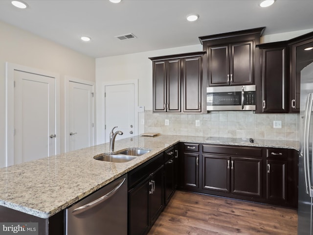 kitchen with backsplash, dark hardwood / wood-style flooring, sink, and appliances with stainless steel finishes