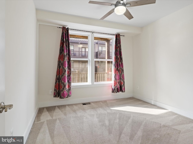 unfurnished room with ceiling fan and light colored carpet