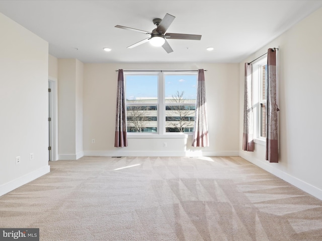 empty room featuring light colored carpet and ceiling fan