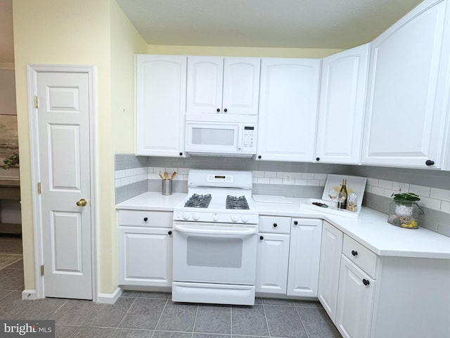 kitchen featuring white cabinetry, white appliances, and decorative backsplash