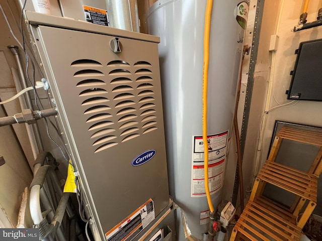 utility room featuring heating unit and gas water heater