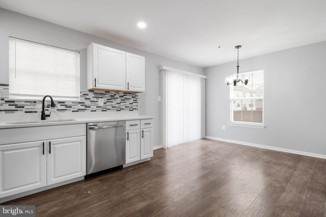 kitchen featuring white cabinets, dark hardwood / wood-style floors, dishwasher, pendant lighting, and sink