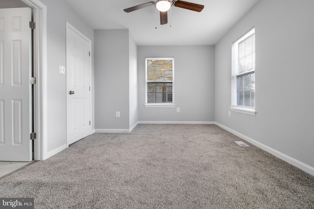 carpeted empty room with ceiling fan