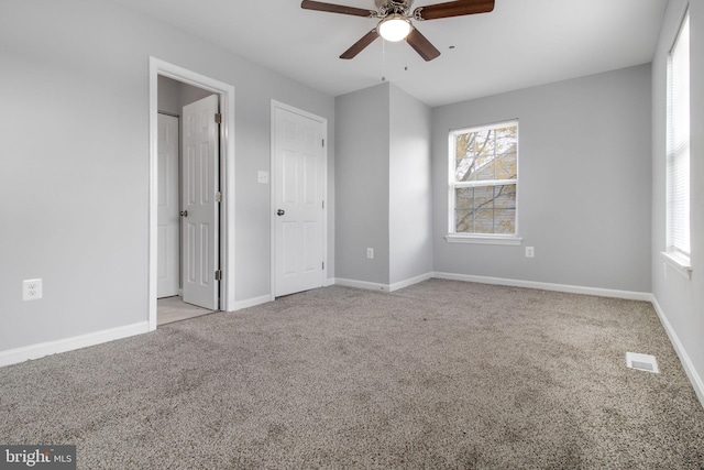 unfurnished bedroom with light colored carpet and ceiling fan