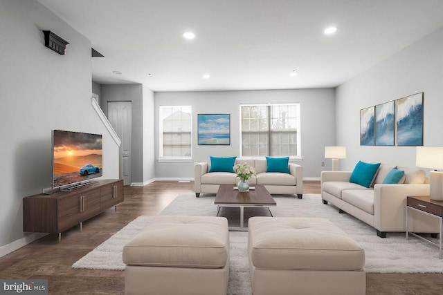 living room with baseboards, wood finished floors, and recessed lighting