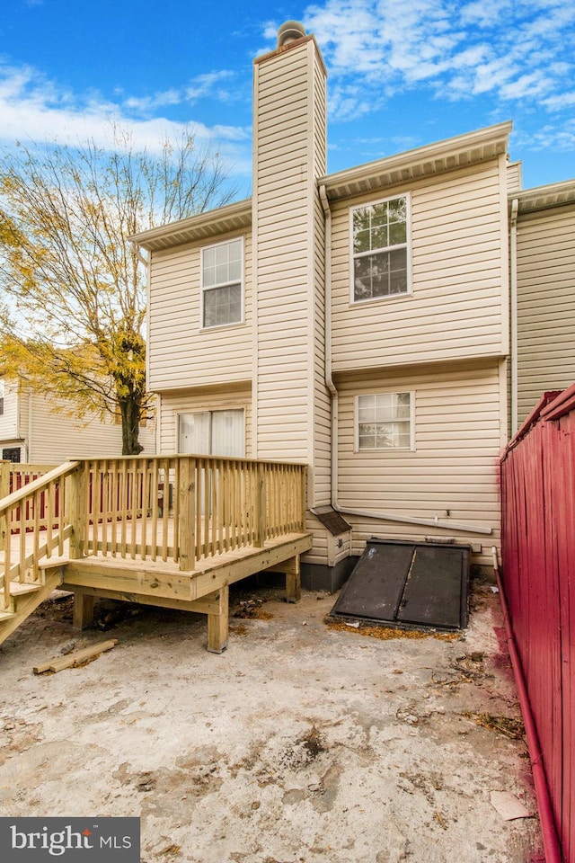 back of house featuring a wooden deck