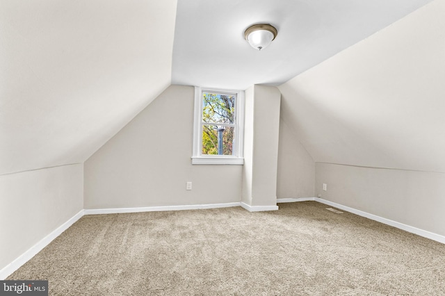 bonus room featuring carpet flooring and vaulted ceiling