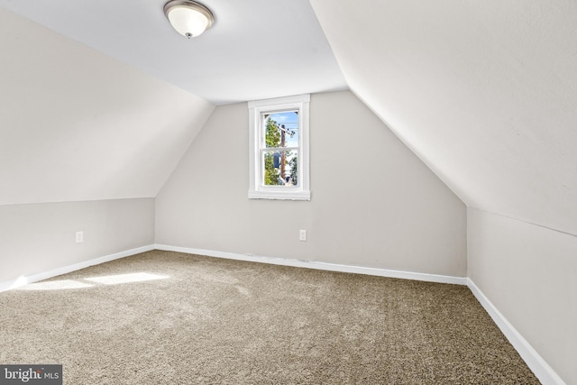 bonus room with carpet and vaulted ceiling