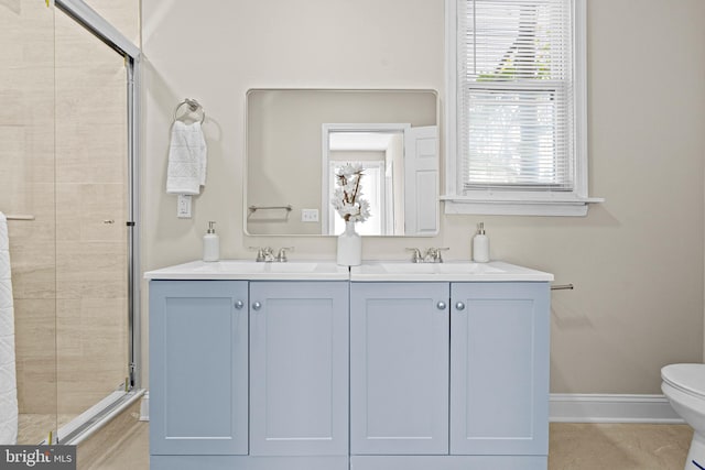 bathroom with toilet, an enclosed shower, and vanity