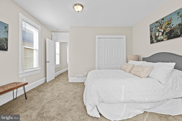 carpeted bedroom featuring a closet