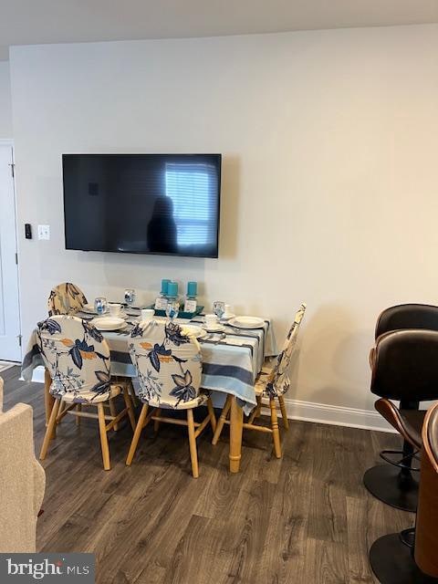 dining room with dark wood-type flooring