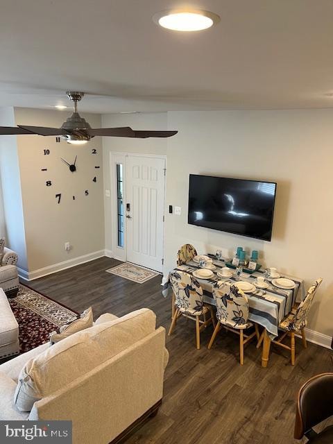 living room featuring dark hardwood / wood-style floors and ceiling fan