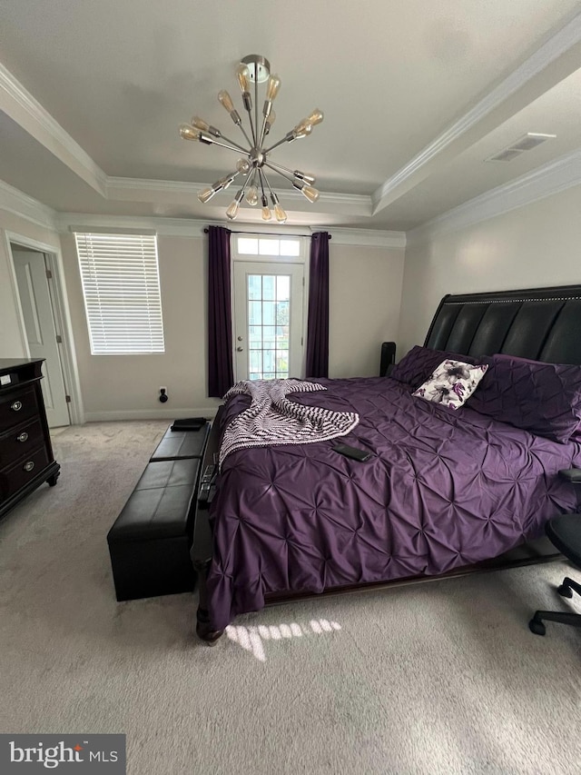 bedroom with an inviting chandelier, ornamental molding, light colored carpet, and a tray ceiling