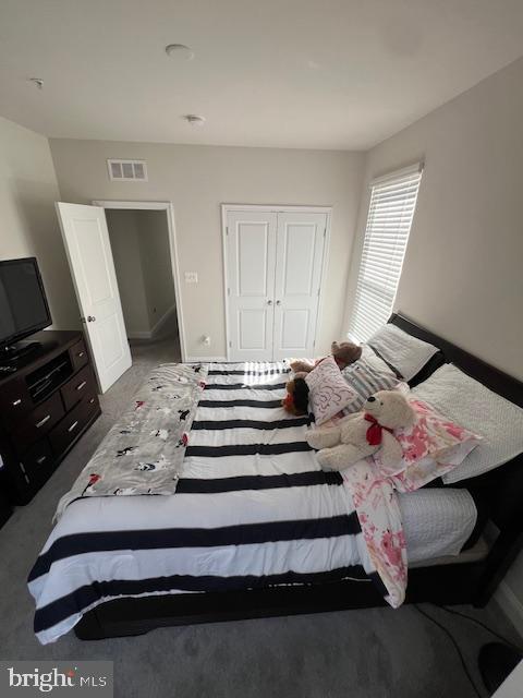 bedroom featuring a closet and carpet floors