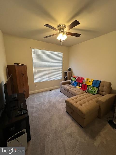 living room featuring ceiling fan and carpet