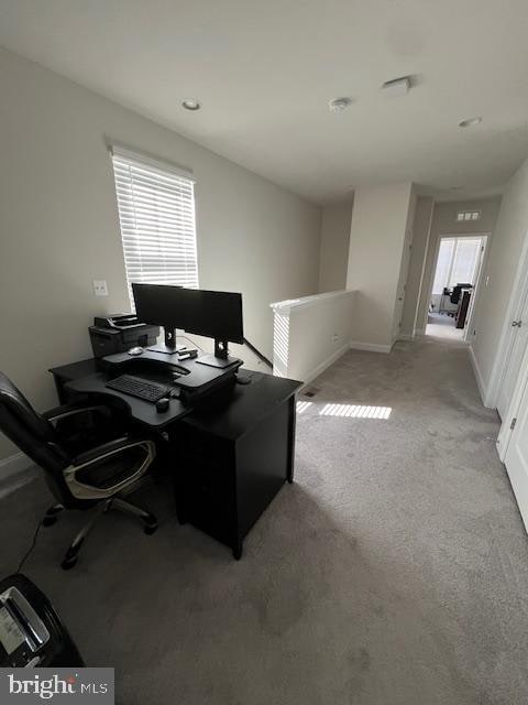 office area featuring light colored carpet