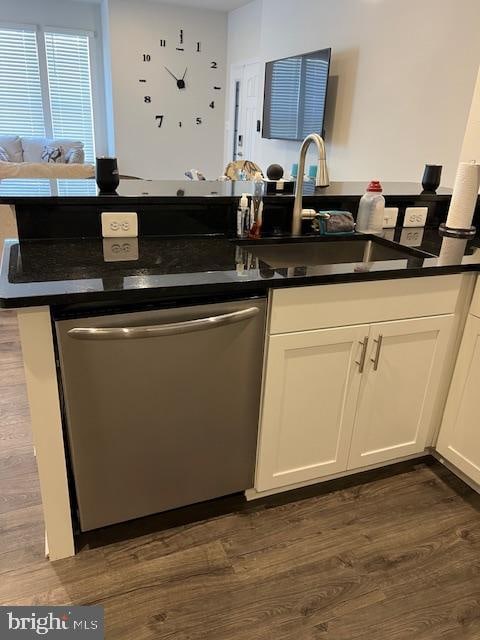 kitchen with dark wood-type flooring, dishwasher, sink, and white cabinets